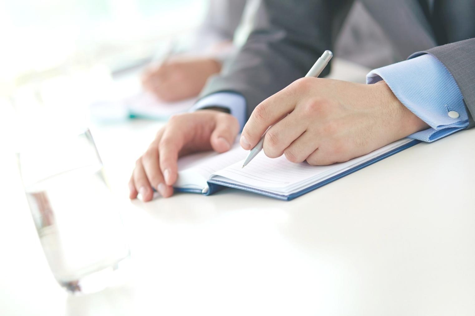 Complex financial modeling workspace with multiple monitors showing spreadsheets and analysis